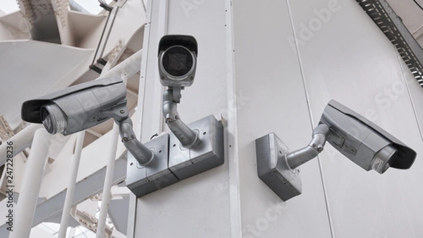 Fototapeta cctv camera security on pole and cement background