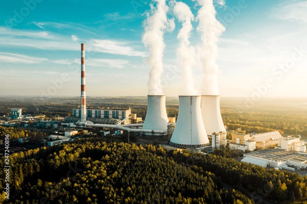 Obraz A Power plant with white smoke over it's chimneys