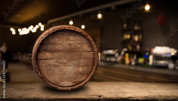 Fototapeta Beer barrel with beer glasses on a wooden table. The dark brown background.