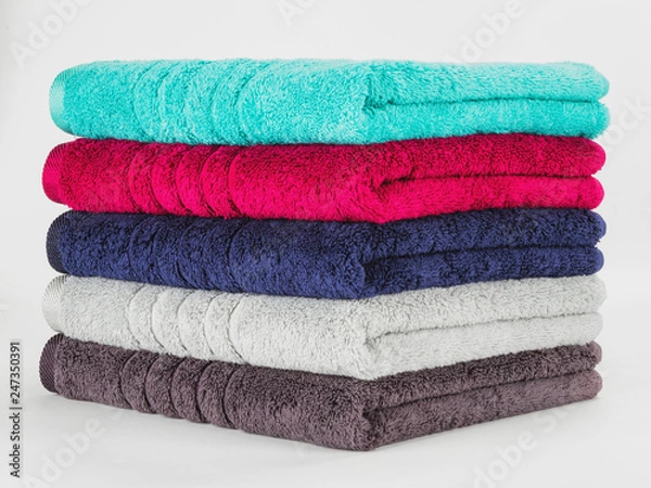 Fototapeta Multicolored towels on a white background