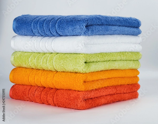 Fototapeta Multicolored towels on a white background