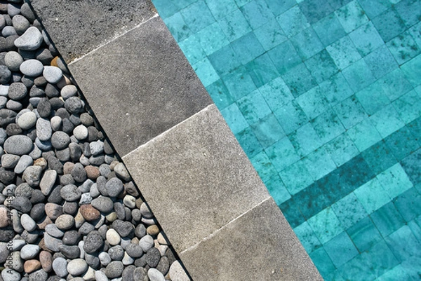Fototapeta Closeup photo of pool edge which decorated with pebbles
