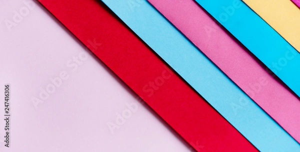 Fototapeta Trendy pastel colors in geometry shape flat lay. Colorful rainbow paper creative linear background.