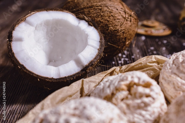Fototapeta Juicy chopped coconut, coconut water in a wooden vessel and coconut chips are ready for use in cooking