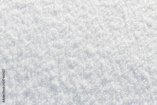 Fototapeta Fresh fluffy snow texture in the sun. Winter background with top view closeup
