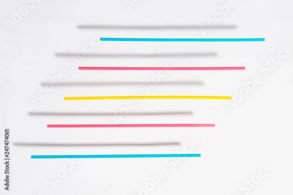 Obraz Colored straws with shadow floating above a white background