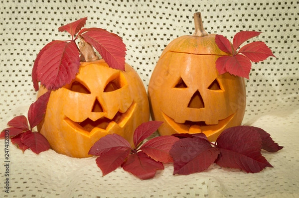 Obraz two amusing pumpkins in a crimson autumn leaf