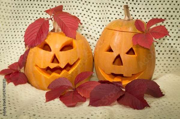 Obraz two amusing pumpkins in a crimson autumn leaf
