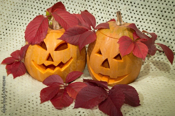 Obraz two amusing pumpkins in a crimson autumn leaf