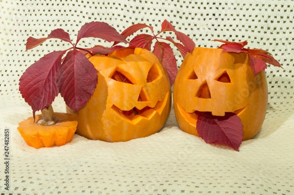 Obraz two amusing pumpkins in a crimson autumn leaf