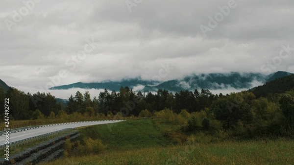 Fototapeta Mountains range, covered with fog, and mountain pass