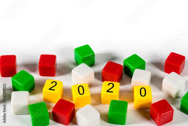 Fototapeta 2020 spelled in blocks among other colorful dice on white background for New Years concept