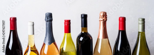 Fototapeta Tops from different kinds new bottles of champagne, white, red wine on light background