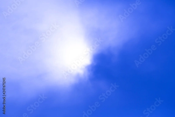 Obraz deep blue sky view with sun behind the cloud