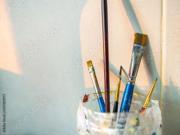 Fototapeta Paint brushes in old plastic cup