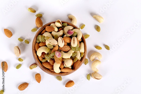 Fototapeta ssorted nuts on white, dry fruits, mix nuts, almond, cashew, pistachio, raisin