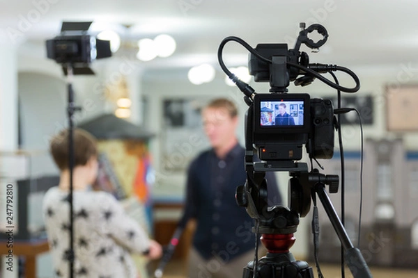 Fototapeta Video of the interview. Television equipment, camcorder with LCD screen, lighting equipment.
