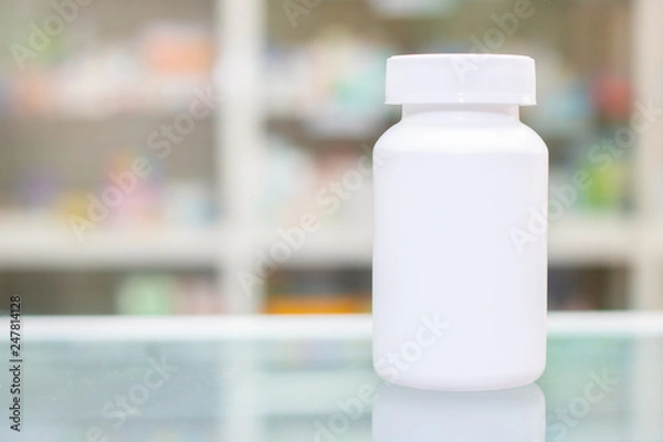 Obraz mock up white plastic bottle for contain pills  in drug store