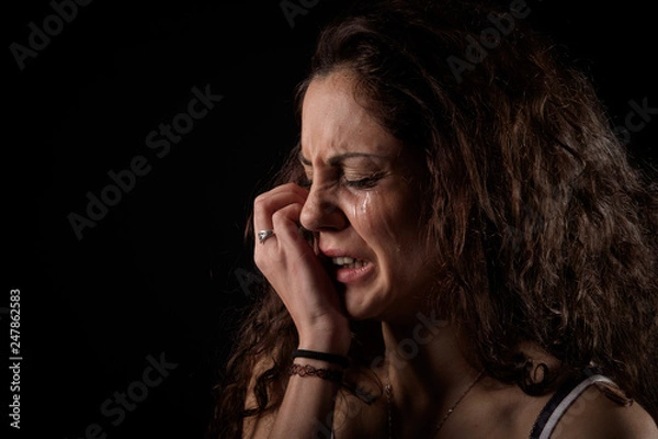 Obraz closeup portrait of a scared woman crying with bruises and wounds marks on her face after a case of gender violence in a young couple