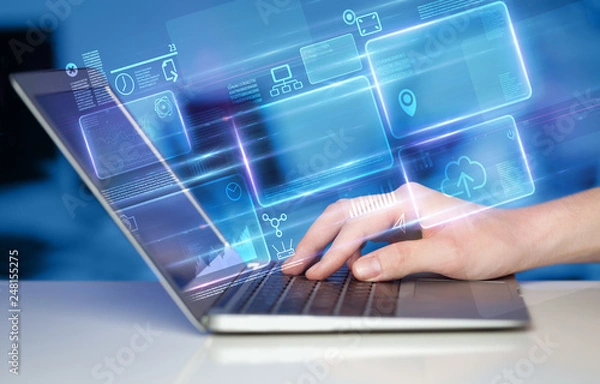 Fototapeta Hand using laptop with database reports and online work concept
