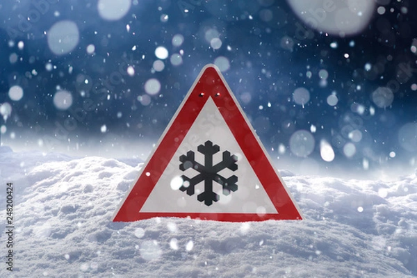 Fototapeta winter driving - risk of snow and ice - traffic sign