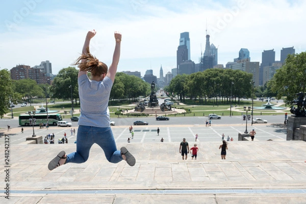 Obraz A women jumping in the iconic film location of Rocky in Philidephia