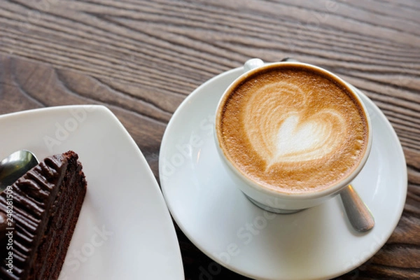 Fototapeta Cappuccino coffee in white cup lay on wooden table,Relax time with coffee and chocolate cake,Art of coffee,Chocolate cake put on wooden table