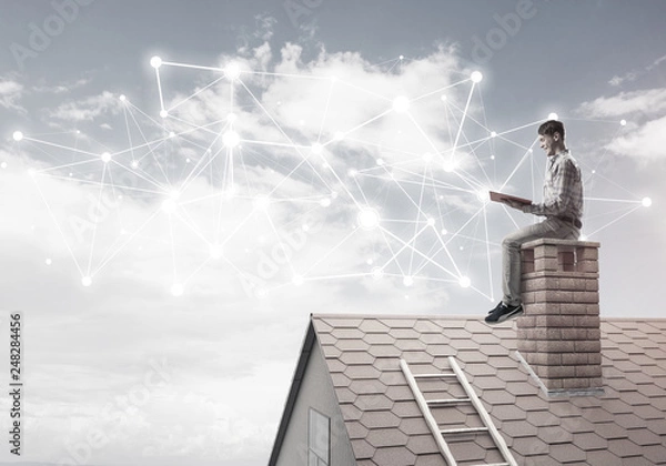 Fototapeta Man on brick roof reading book and concept of social connection