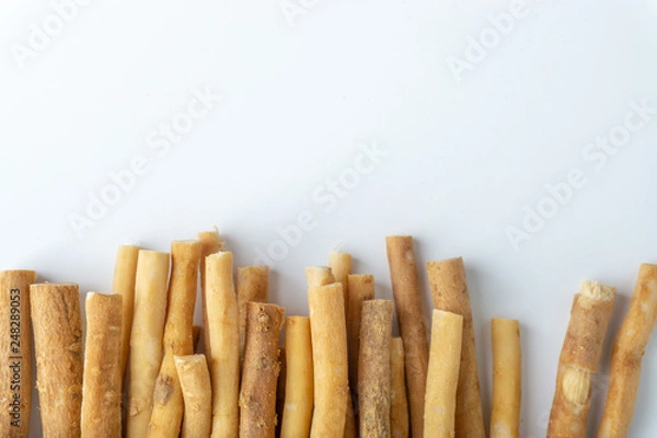 Obraz Natural toothbrush Miswak (Kayu Sugi) on white background with selective focus. It is a teeth cleaning twig made from the Salvadora persica tree and also know as miswaak, siwak, Sugi or sewak