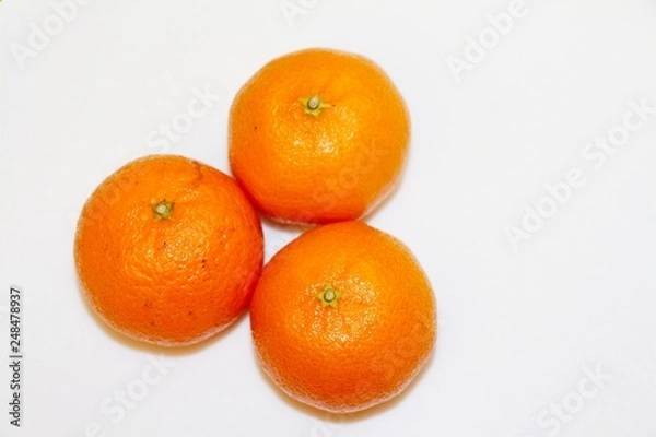 Fototapeta Three mandarins isolated on white background and space for your text.