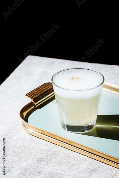Fototapeta Pisco Sour, a cocktail with Pisco, lime or lemon juice, egg white, and angostura bitter in pop contemporary style.