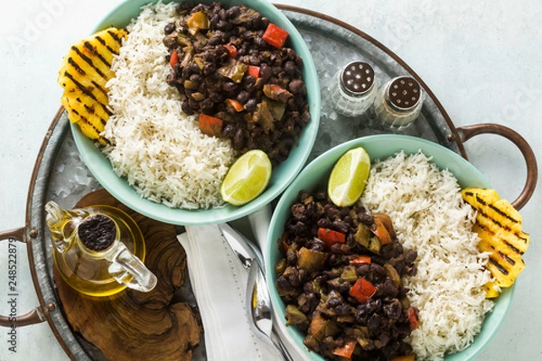 Obraz Cuban rice and black bean dish with grilled pineapple. Healthy Vegan Caribbean food for the whole family, party or restaurant menu