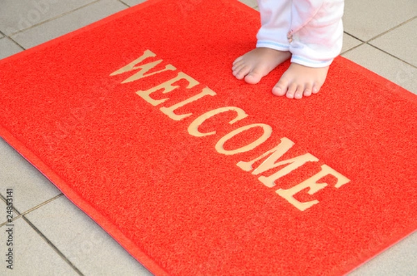 Obraz Child Standing On A Red Welcome Mat