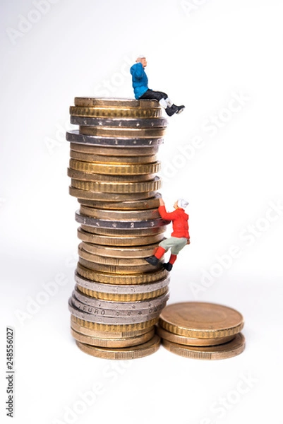 Obraz Miniature climbers climbing on the stack of coins