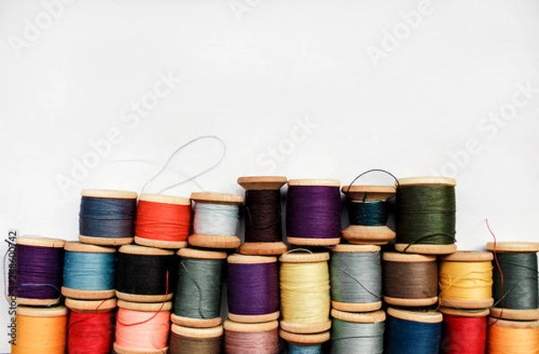 Fototapeta Sewing thread colored on white background