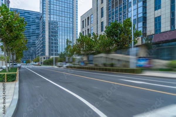 Fototapeta city empty traffic road with cityscape in background.