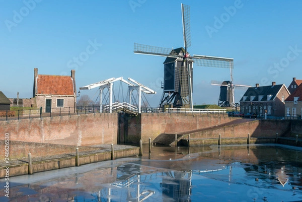 Obraz Drawbridge and windmills