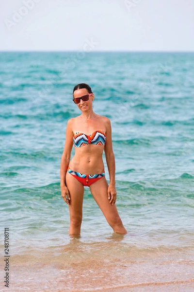 Obraz Attractive young woman resting on the beach by the sea