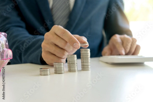 Obraz Business man hold collect coin in the row