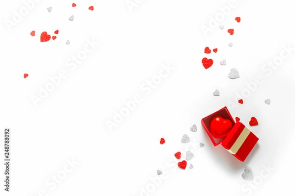 Fototapeta White holiday background with present gift box and little hearts on background. Valentine's day greeting concept. Top view, flat lay, copy space. 