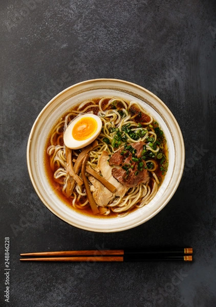 Fototapeta Ramen asian Noodle in broth with Meat and Ajitama pickled Egg in bowl on dark background
