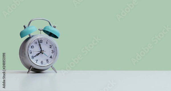 Fototapeta Retro styled white alarm clock, isolated and copy space, green