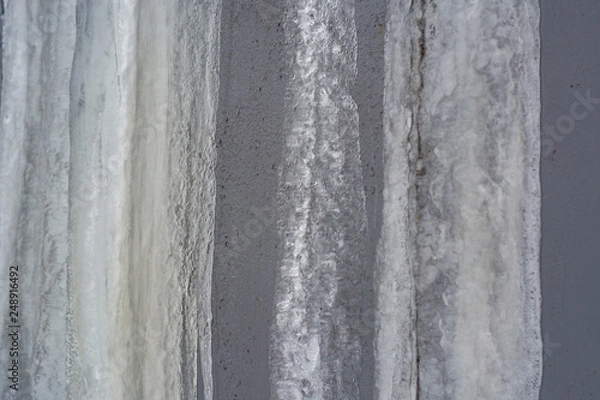 Fototapeta Frozen streams of water on a metal surface