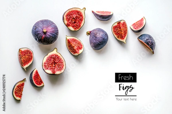 Fototapeta Fresh figs.Food Photo. Creative diagram of a whole and sliced ​​figs on a white background with space for text. View from above. Copy space