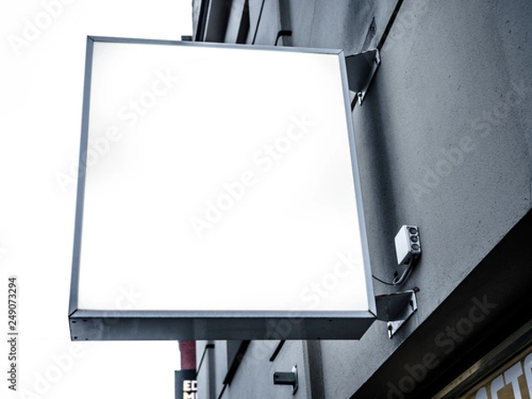 Fototapeta Mock up. Outdoor advertising, blank billboard outdoors, public information board on the wall, Signboard side view of empty white with shadow mock up signage.