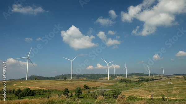 Fototapeta Windmill farm with blue sky and clouds