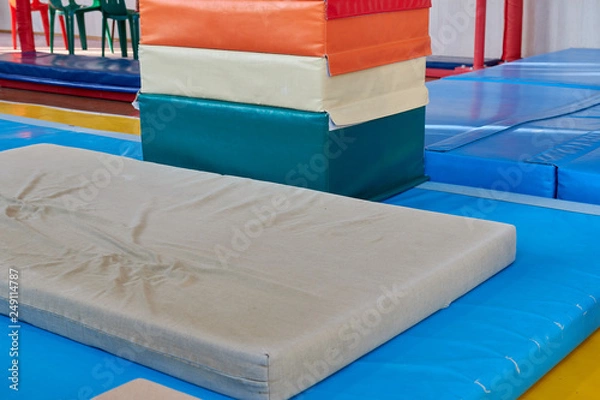 Fototapeta hall for gymnastics at school. multi-colored mats. doing sports. sports equipment. healthy lifestyle. sport competitions