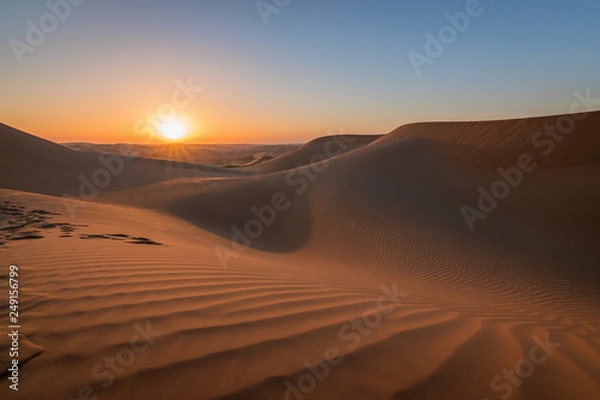Fototapeta Sunset in the desert with beautiful sand dunes.