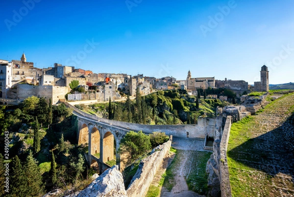 Obraz Gravina in Puglia, with the Roman two-level bridge that extends over the canyon. Apulia, Italy.
