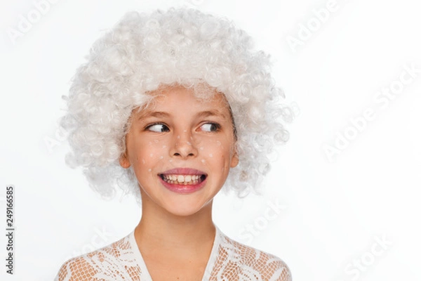Obraz Portrait of a cheerful, energetic eight-year-old girl in a white wig and with white freckles